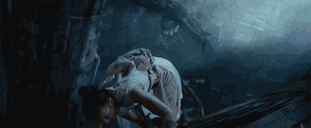 a woman in a white dress is crawling on the ground