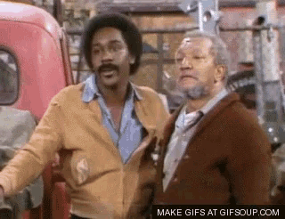 two men are standing next to each other in front of a red truck and a sign that says make gifs