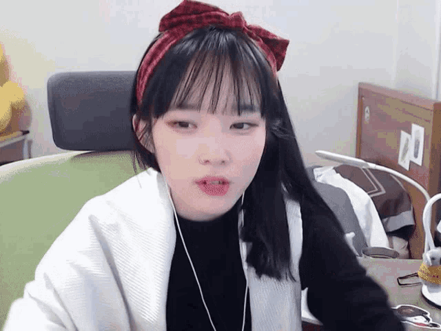 a girl wearing headphones and a headband with a bow on it