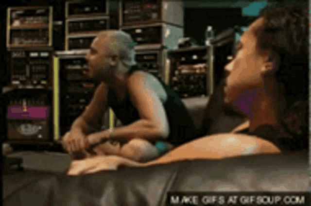 a couple of people sitting on a couch with a make gifs at gifsoup.com watermark in the corner