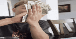a man is holding a bunch of money in his hands