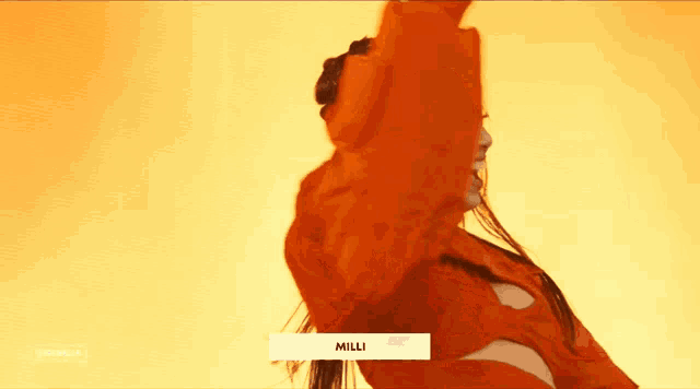 a woman in a red jacket is smiling and dancing