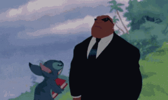 a cartoon of a man in a suit and tie standing next to stitch