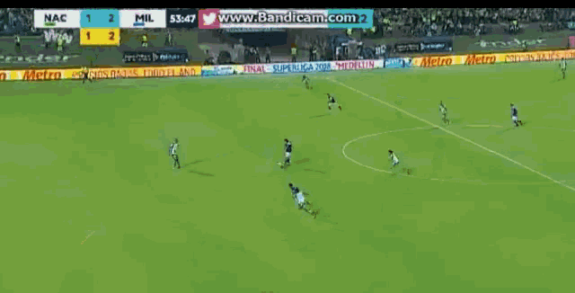 a soccer game is being played with ads for aguila and nac