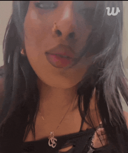 a close up of a woman 's face with the letter w visible