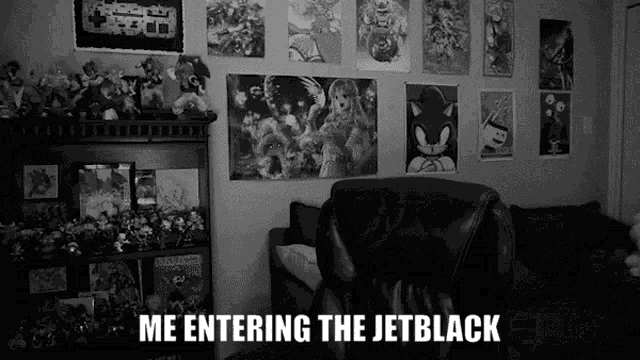 a black and white photo of a living room with posters on the wall and the words me entering the jetblack