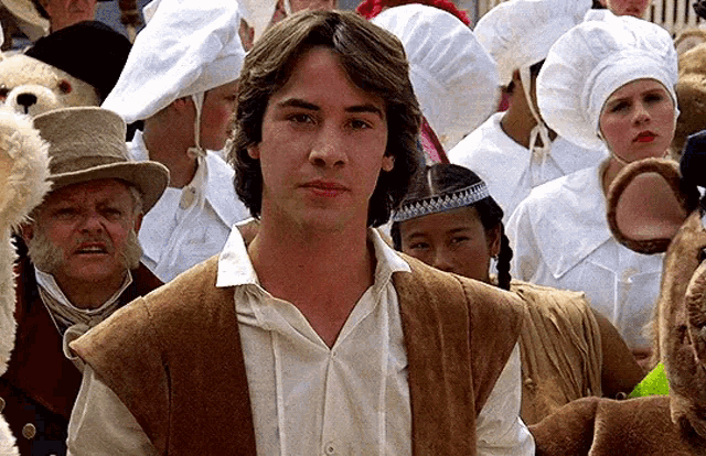 a man in a brown vest is in a crowd of people