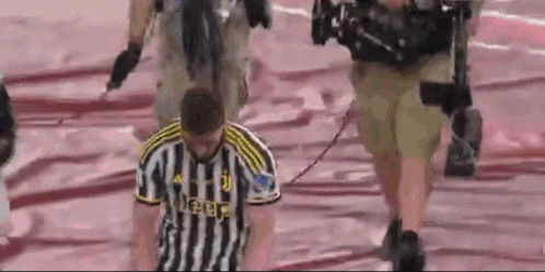 a man wearing a jersey that says juventus is tied to a camera