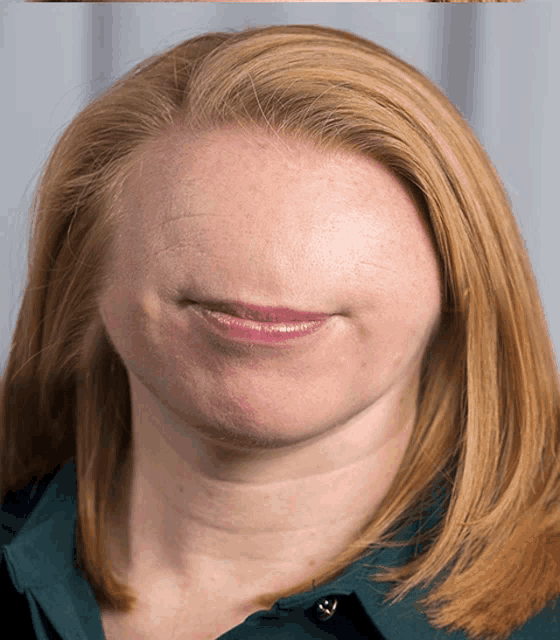 a close up of a woman 's face with the mouth open