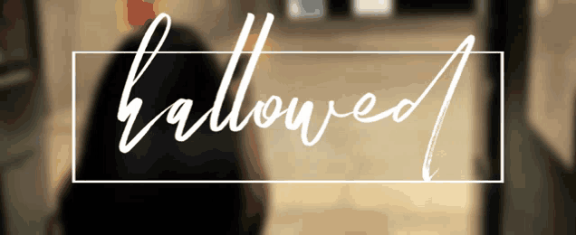a blurred image of a person with the word hallowed written in white