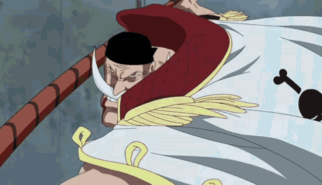a man with a white beard and a red cape has a key on his shirt