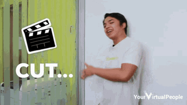 a man is standing in front of a clapper board that says " cut " on it