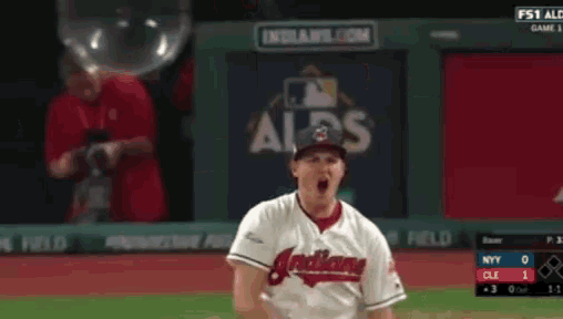 a baseball player wearing an indians jersey is celebrating