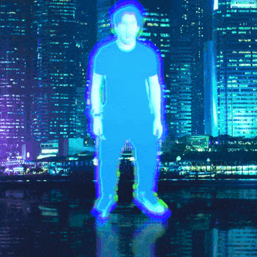 a man is standing in front of a city at night