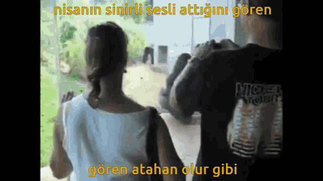 a man and a woman are looking out a window with a caption that says nisanin