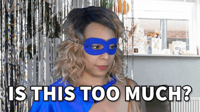 a woman wearing a blue mask with the words is this too much behind her