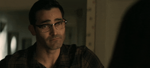 a man wearing glasses and a plaid shirt
