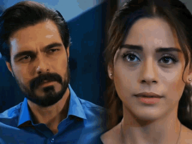 a man with a beard and a woman with a serious look on her face