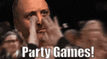 a man covering his face with his hands while a crowd applauds and says party games