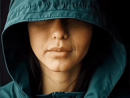 a close up of a woman wearing a hoodie
