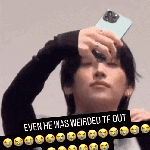 a picture of a man holding a cellphone with a caption that says " even he was weirded tf out "
