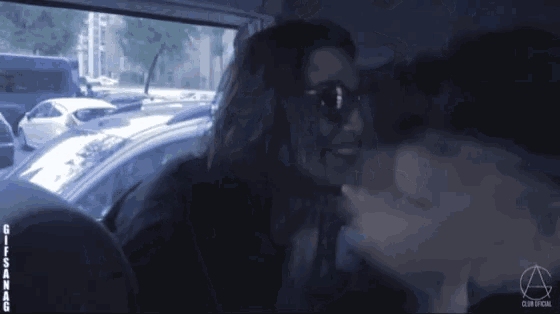 a man and a woman are kissing in a car with the words club social on the bottom right