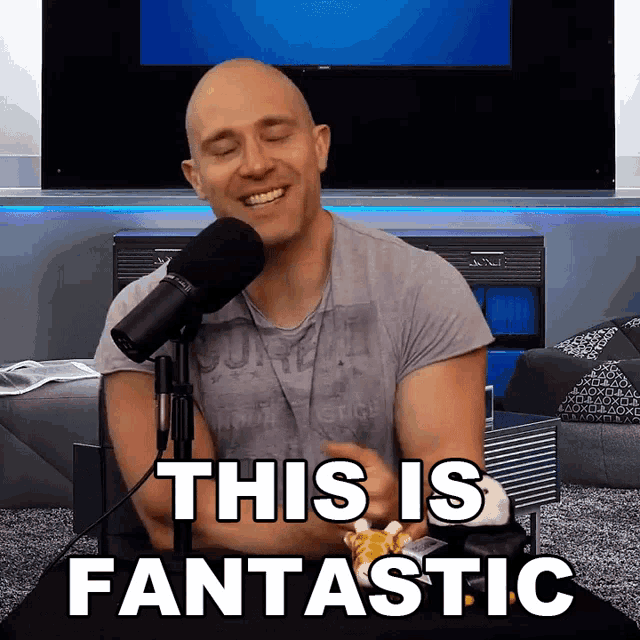 a bald man sitting in front of a microphone with the words this is fantastic