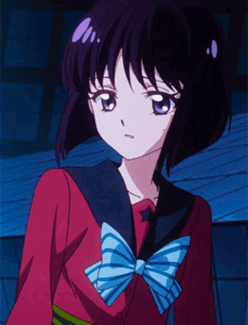 a girl with short black hair and purple eyes is wearing a red shirt and a blue bow