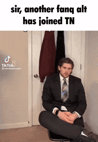 a man in a suit and tie is sitting on a chair with his legs crossed and a caption that says sir another fang alt