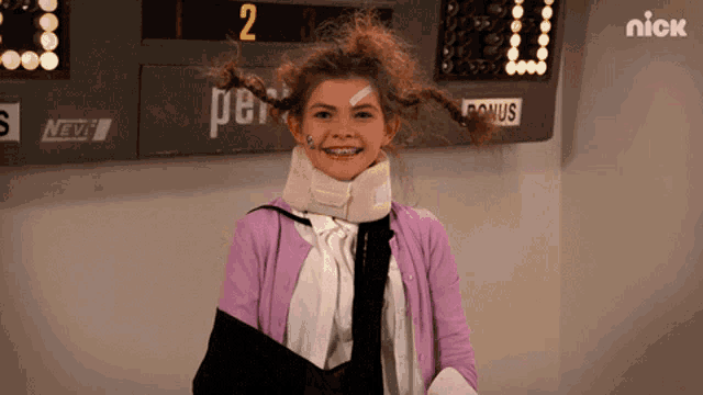 a girl wearing braces and a purple sweater stands in front of a scoreboard that says nick