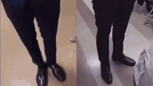 a couple of men standing next to each other on a floor wearing black shoes .