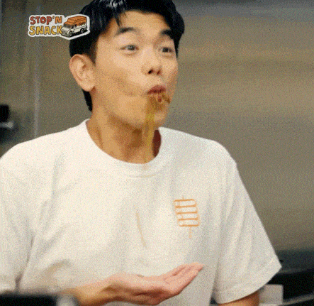 a man in a white shirt with a stop 'n snack sticker on his shirt