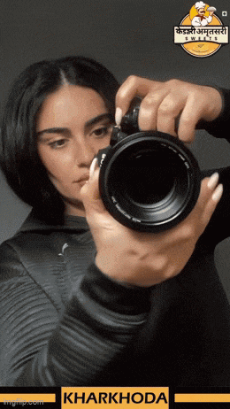 a woman is taking a picture with a camera with kharkhoda written on the bottom
