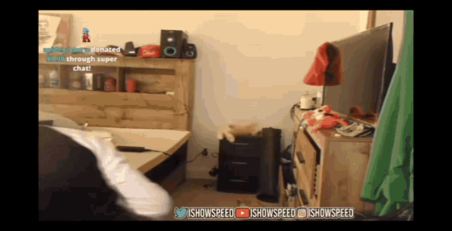 a room with a green screen and the words ' ishowspeed ' at the bottom