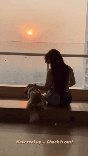 a woman sits on a balcony with a dog and the words new reel up check it out below her