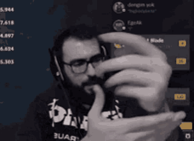 a man wearing glasses and headphones is taking a selfie with his phone