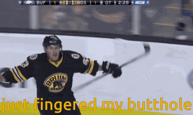 a hockey player in a bruins jersey is holding a hockey stick