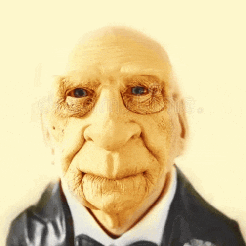 a close up of an old man wearing a tuxedo
