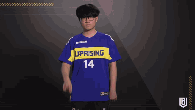 a man wearing a blue uprising 14 jersey