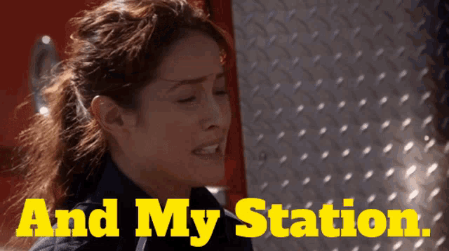 a woman stands in front of a fire truck with the words " and my station " written in yellow