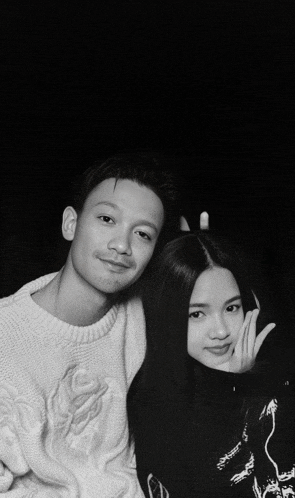 a black and white photo of a man and a woman with the letter d on the bottom right