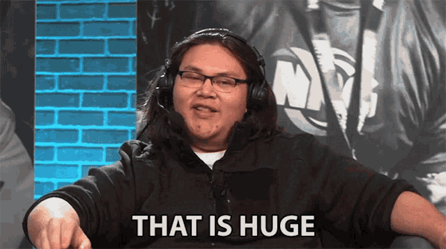 a man wearing headphones and glasses is saying that is huge