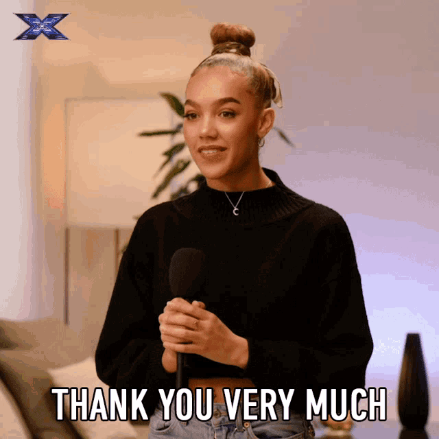 a woman holding a microphone with the words thank you very much below her