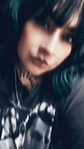 a blurry picture of a person 's face with a hood on