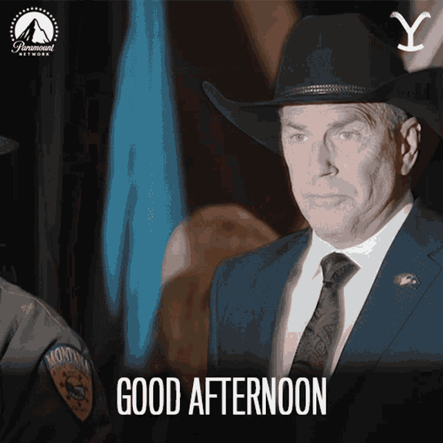 a man in a suit and tie says good afternoon in a paramount network ad