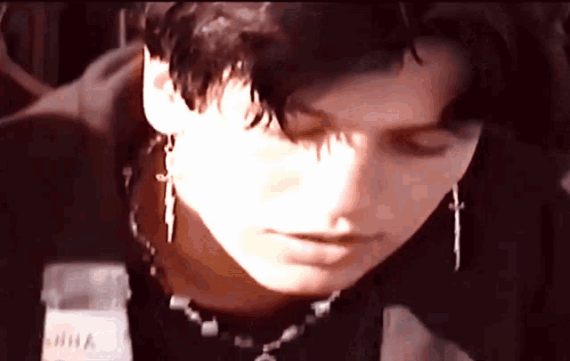 a close up of a person 's face with a bottle of milk in the foreground