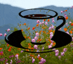 a cup of coffee sits on a saucer in a field of flowers