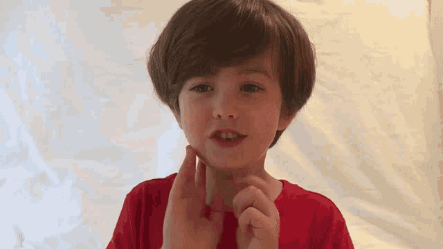a young boy is making a face with the words oh my god behind him