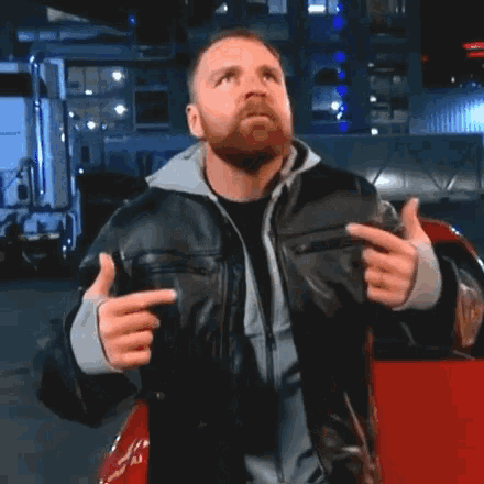 a man with a beard is wearing a leather jacket
