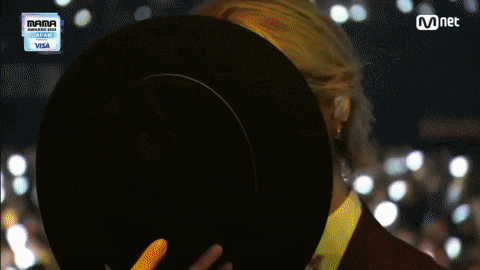 a person covering their face with a hat with a visa logo on the bottom right
